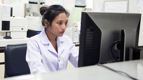 Doctor working on a computer in the office of the hospital or a laboratory